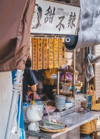 A night market stall hung with hand-written signs